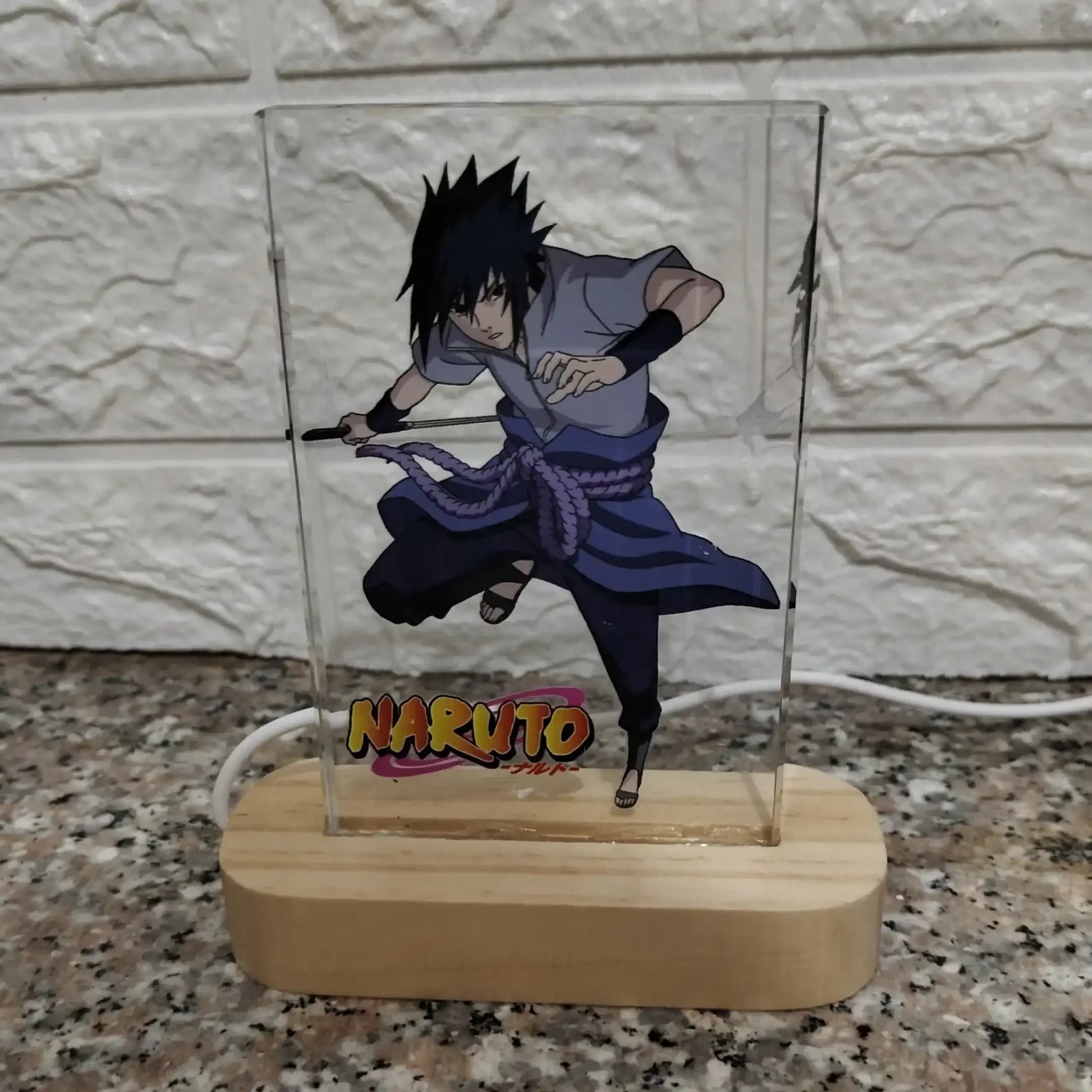 Anime character lamp with 'Naruto' branding on a marble surface.
