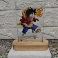 Anime character figurine on a stand with a glass cover against a textured wall background