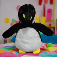 Plush penguin toy on a textured surface with a light gray background