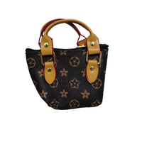 Small handbag with star pattern and brown handles on a marble surface.