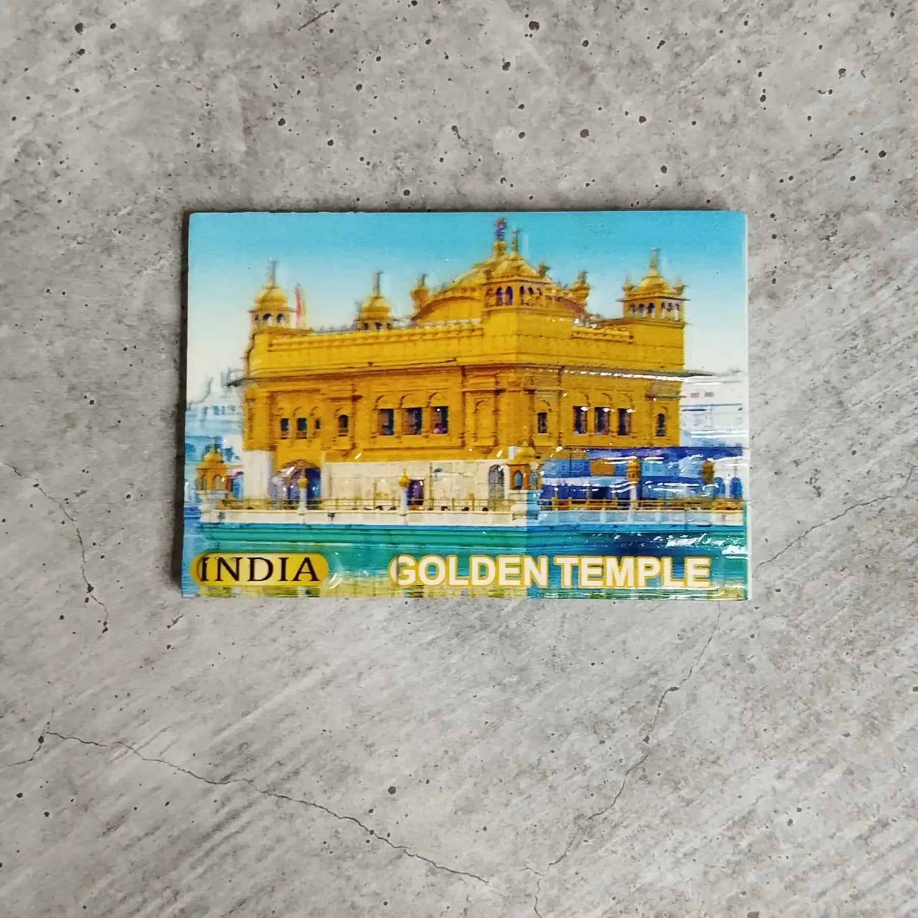 Colorful magnet of the Golden Temple on a concrete surface