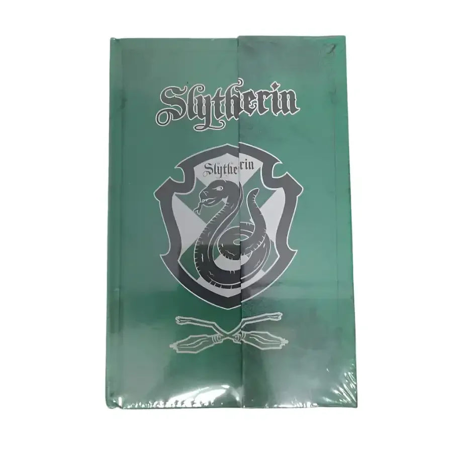 Green notebook with 'Slytherin' emblem on a gray concrete surface