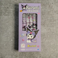 Kuromi-themed stationery set packaging on a gray concrete surface