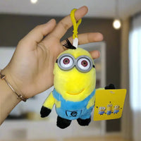 Plush toy keychain with a tag held by a hand against a neutral background