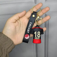 Keychain with virat kohli jersey design held by a hand against a neutral background