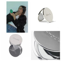 Collage of a person holding a compact mirror and multiple views of a silver compact mirror with 'mode' branding.