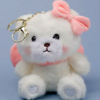 White plush toy with a pink bow and heart on a light blue background
