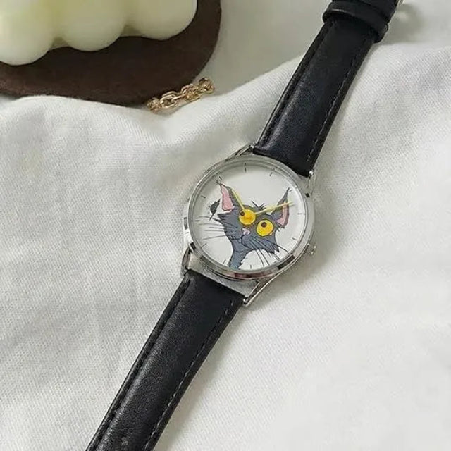 Wristwatch with a cat face design on the dial, black leather strap, on a white fabric background