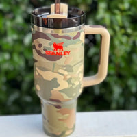 Post Malone Stanley tumbler with handle and straw on a blurred green background