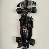 Model of a Formula 1 car with visible branding on a light gray background