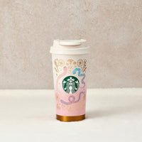Starbucks tumbler with snake design on a neutral background