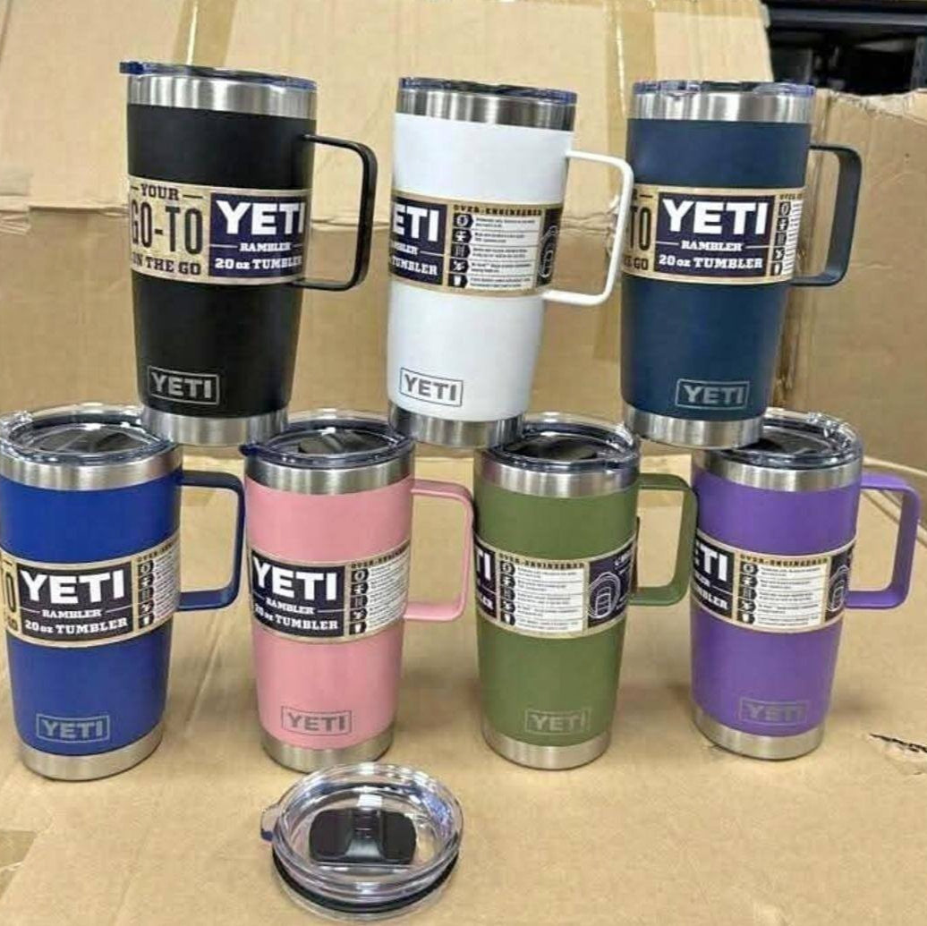 Collection of colorful YETI tumblers on a cardboard surface