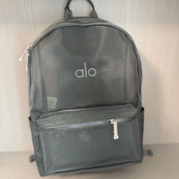 Gray backpack with 'alo' logo held by a hand against a neutral background