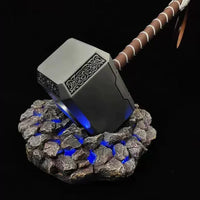 Decorative hammer with LED base on a black background