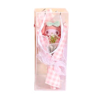 Plush toy in a clear gift bag with a pink checkered pattern on a white background