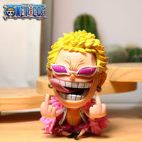 Action figure with yellow hair and pink sunglasses on a wooden surface, featuring One Piece logo.