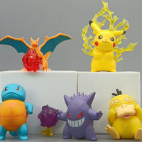 Collection of colorful toy figures on a white block with a gray background