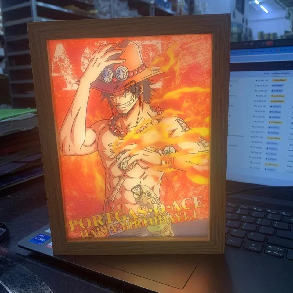 Framed night lamp of portugas d. ace on a desk with a computer in the background