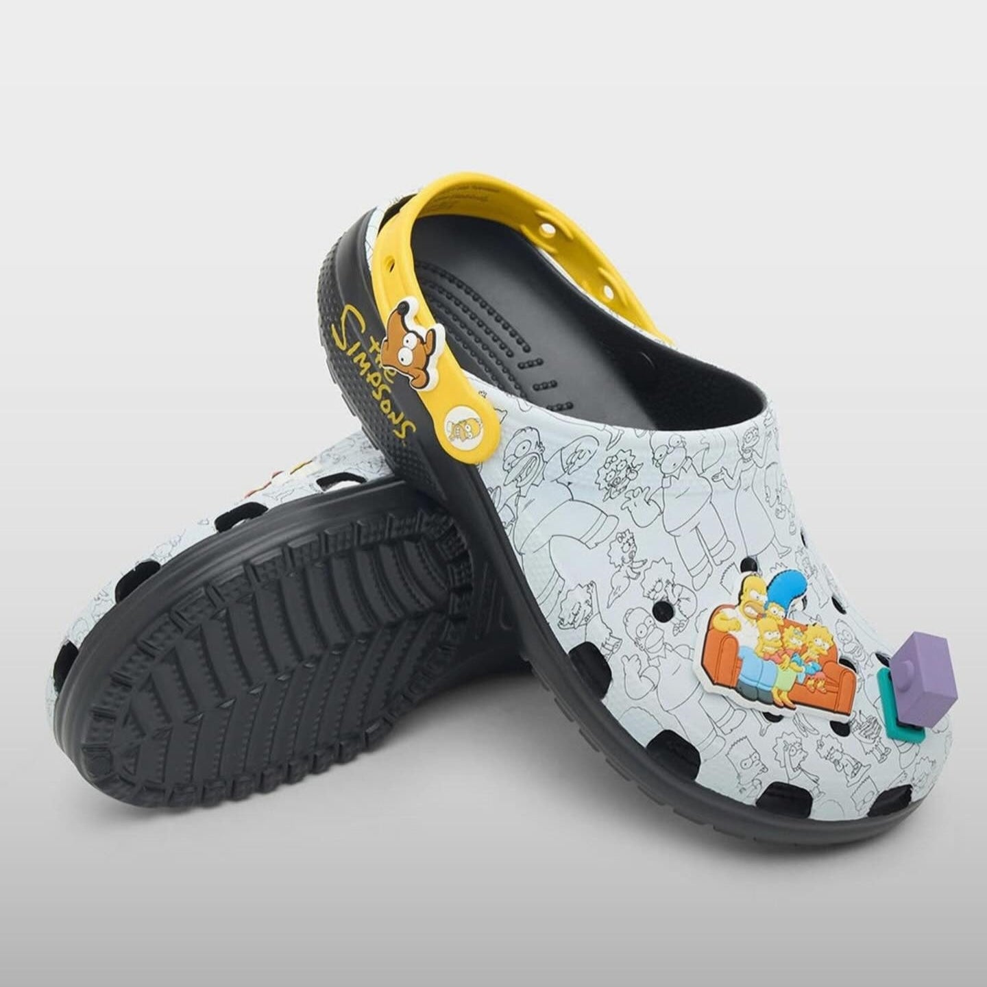 Colorful children's clogs with cartoon design on a gray background