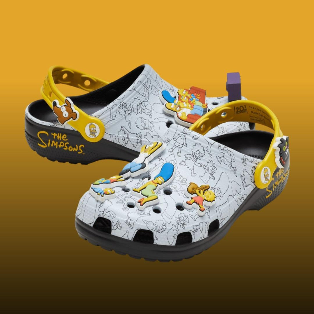 Pair of 'The Simpsons' themed clogs on a gradient background