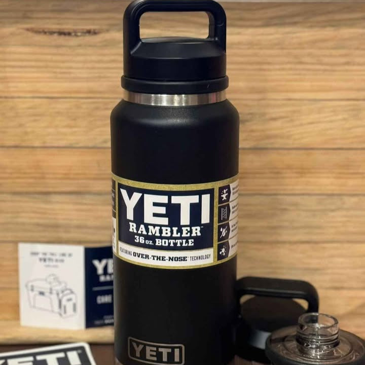 Black YETI Rambler bottle with a wooden background