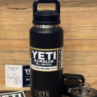 Black YETI Rambler bottle with a wooden background