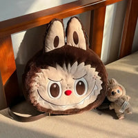Plush bag with cartoon face design on a wooden surface