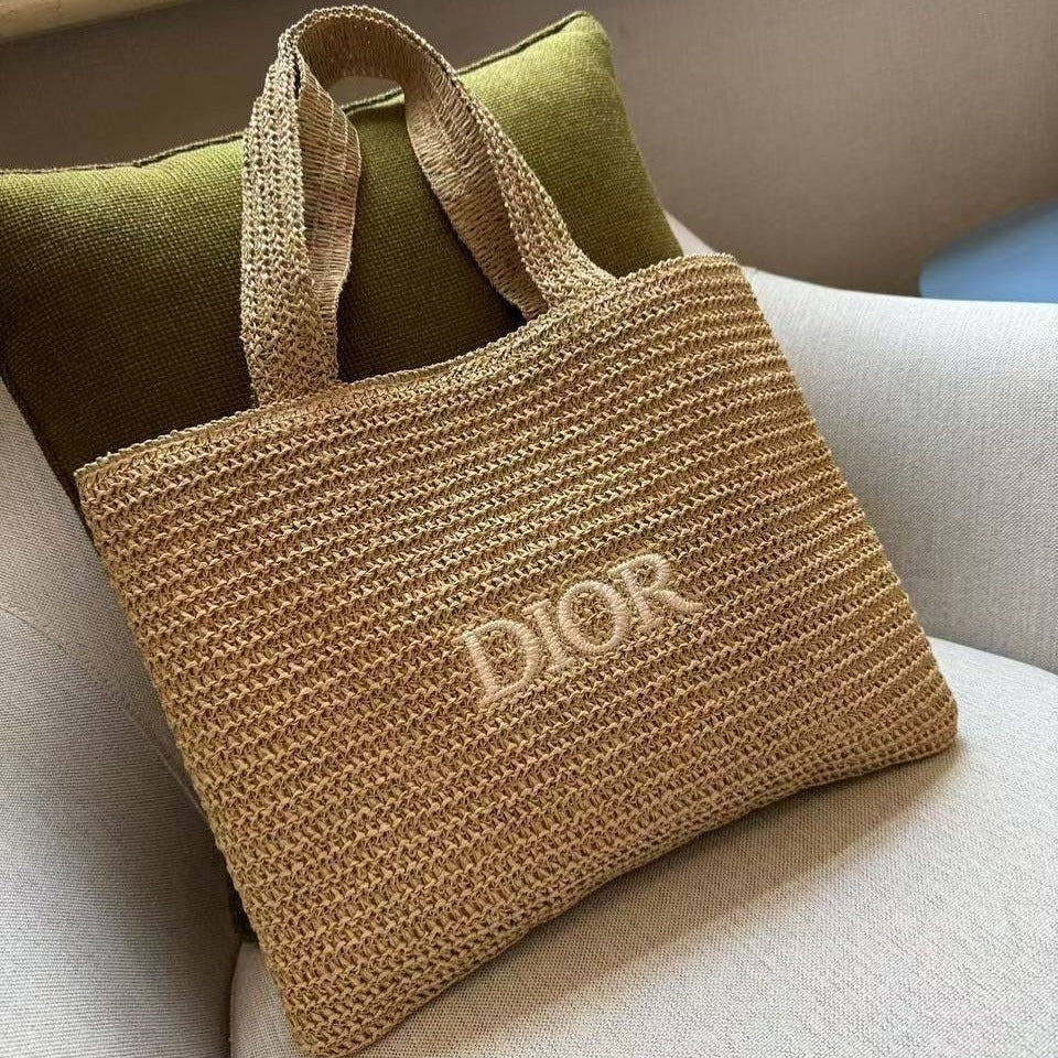Brown woven handbag with 'Dior' logo on a light-colored surface