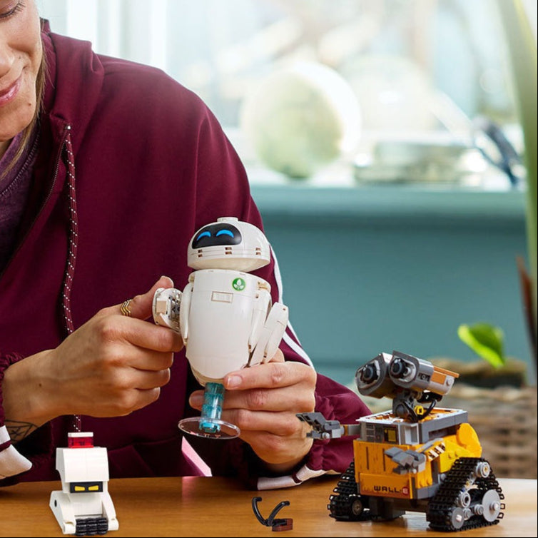 Person holding a robot toy with text about Disney-themed products