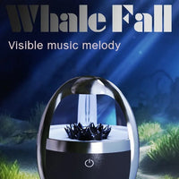 Magnetic fluid Bluetooth speaker with a blue and black design on a grassy background