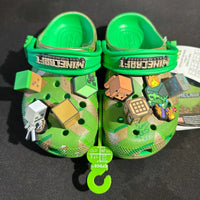 Green children's crocs with Minecraft design on a black background