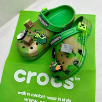 Green Crocs shoes with Minecraft design on a green Crocs branded bag.