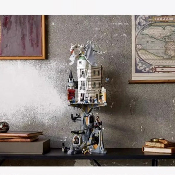 Decorative shelf with model buildings against a textured wall with framed pictures.