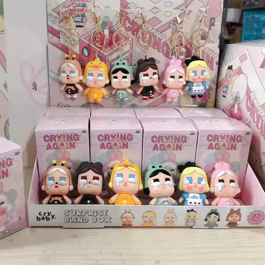Collection of 'Crying Again' themed figurines in a display box with packaging.