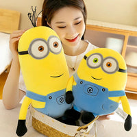 Person holding two yellow plush Minions in a basket.