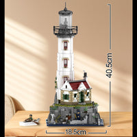 Model of a lighthouse made from building blocks with measurements on a wooden surface.