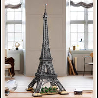 Model of the Eiffel Tower on a table with a room in the background