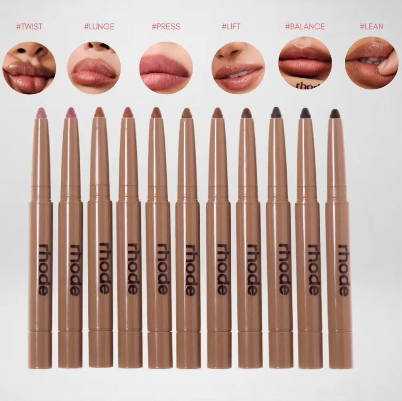 Set of lip pencils with 'rhode' branding and sample lip swatches above them.