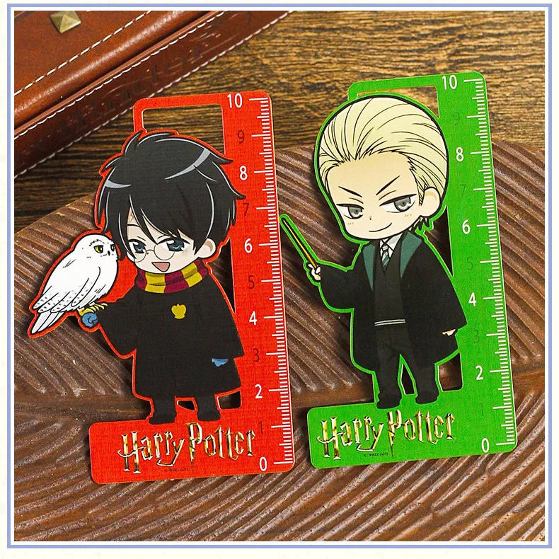 Two Harry Potter-themed rulers with character designs on a wooden surface.