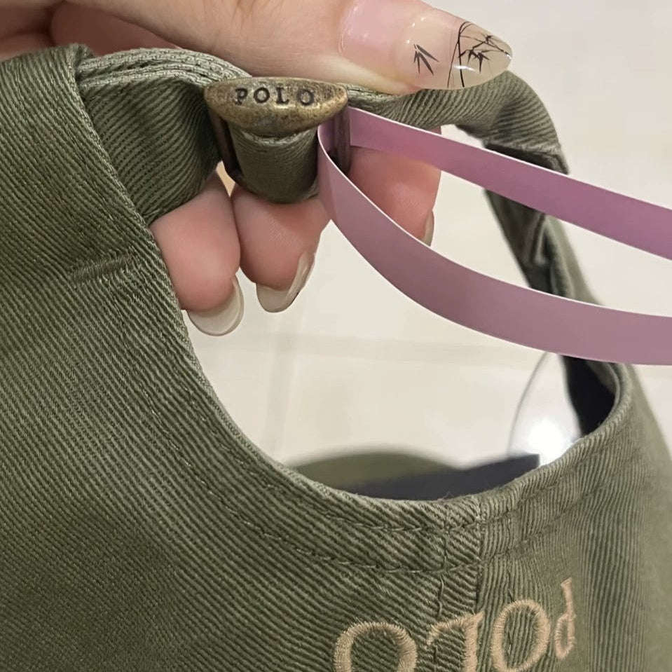 Green cap with 'POLO' branding held by a hand